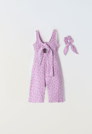 Purple EBITA jumpsuit with matching hair scrunchie.