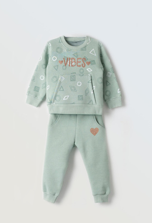 EBITA tracksuit set in verman color with embossed "VIBES" logo.