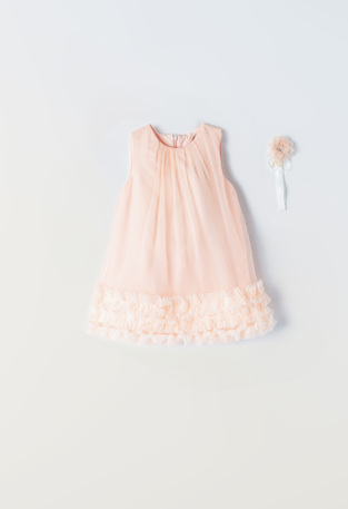 EBITA tulle dress in salmon color with ruffles at the hem.