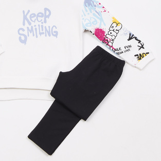 Set of TRAX tights in off-white with "KEEP SMILING" logo embossed.