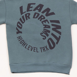 TRAX bodysuit set in petrol color with embossed "LEAN INTO YOUR DREAMS" logo.